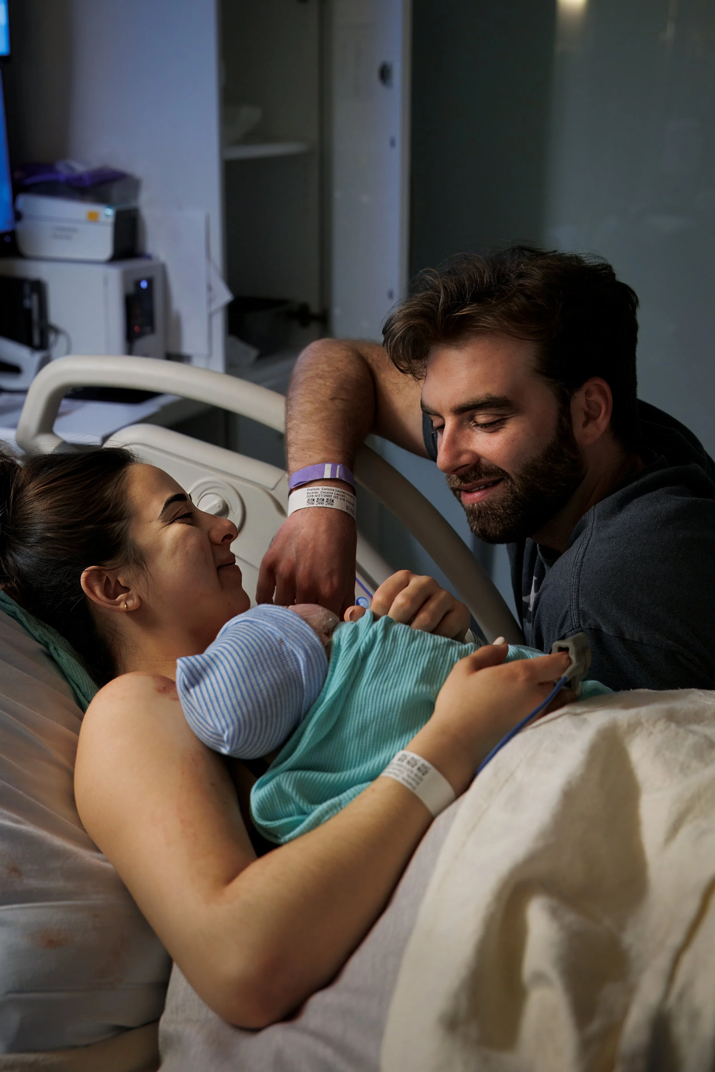 New parents gazing at their newborn in the hospital